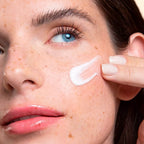 Close-up of a person applying Cultiv Hydra Protect face cream to their face