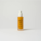Radiance serum bottle with white cap and orange liquid on a light gray background